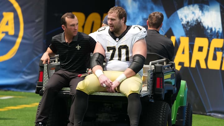 Aug 10, 2025; Inglewood, California, USA; New Orleans Saints offensive tackle Trevor Penning (70) leaves the field with an injury in the first half against the Los Angeles Chargers at SoFi Stadium. Mandatory Credit: Kirby Lee-Imagn Images