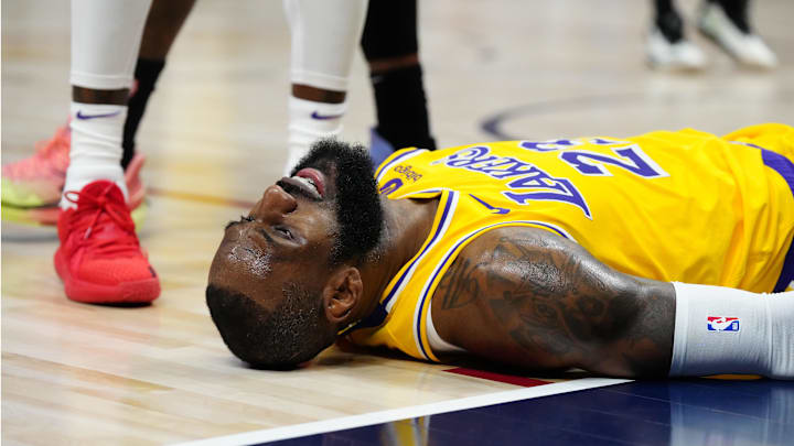 Apr 22, 2024; Denver, Colorado, USA; Los Angeles Lakers forward LeBron James (23) lays on the court