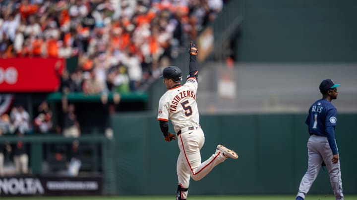 Yastrzemski celebrates as he rounds the bases. 