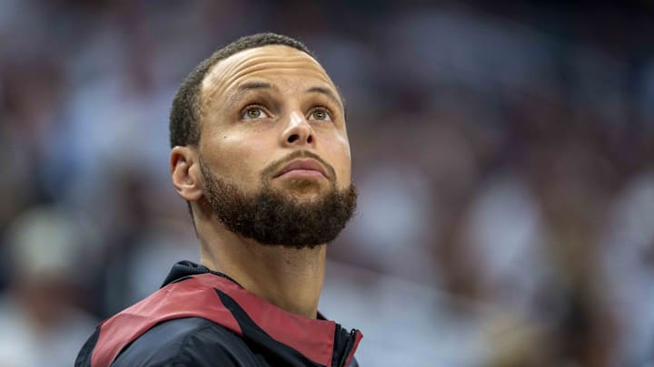 Golden State Warriors guard Stephen Curry looks on from the bench against the Minnesota Timberwolves.