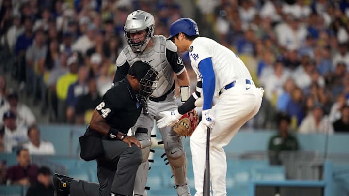 Shohei Ohtani and White Sox catcher Kyle Teel check on umpire Alan Porter after he was hit by a foul ball. Shohei Ohtani and White Sox catcher Kyle Teel check on umpire Alan Porter after he was hit by a foul ball.