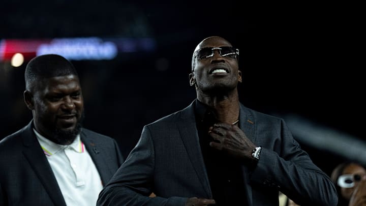 Chad Johnson has a commemorative jacket put on him after being announced as as being a Bengals Ring of Champions inductee at halftime of the NFL game between the Cincinnati Bengals and Los Angeles Rams at Paycor Stadium in Cincinnati on Monday, Sept. 25, 2023.