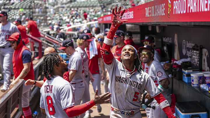 May 15, 2025; Cumberland, Georgia, USA; Washington Nationals shortstop CJ Abrams (5) has seeds tossed at him by third base Jose Tena (8) after hitting a home run against the Atlanta Braves during the eighth inning at Truist Park