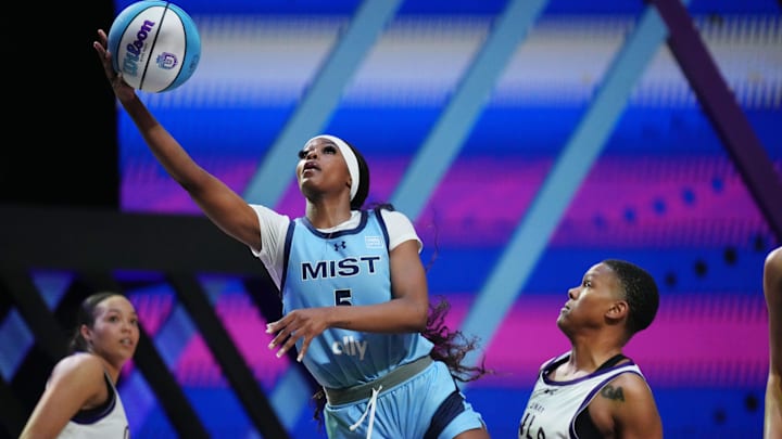 Jan 17, 2025; Miami, FL, USA;  Rickea Jackson (5) of the Mist drives to the basket past Courtney Williams (10) of the Lunar Owls during the second half of the Unrivaled women’s professional 3v3 basketball league at Wayfair Arena. Mandatory Credit: Jim Rassol-Imagn Images