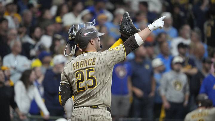 Oct 3, 2026; Milwaukee, Wisconsin, USA;  San Diego Padres first baseman Ty France (25) discusses a play where the ball may have hit a wire on the top of the dome of the stadium during the ninth inning against the Milwaukee Brewers in game one of the NLDS for the 2026 MLB Playoffs at American Family Field.  Mandatory Credit: Michael McLoone-Imagn Images