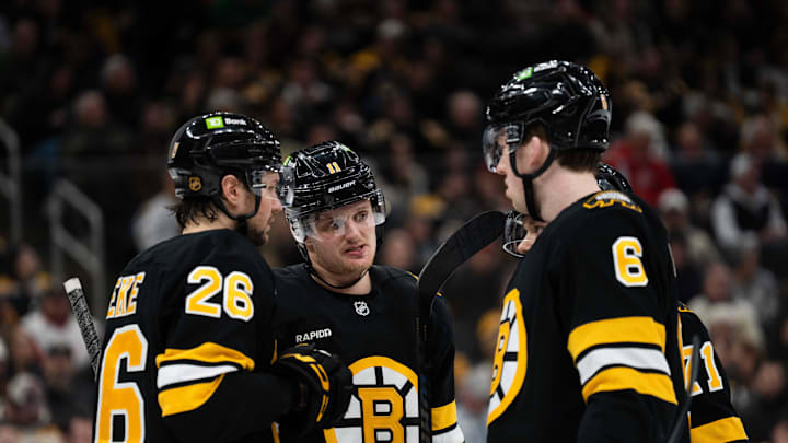 Jan 13, 2026; Boston, Massachusetts, USA; Boston Bruins defenseman Andrew Peeke (26), center Casey Mittelstadt (11), and defenseman Mason Lohrei (6) talk during a stop in play during the second period of the game against the Detroit Red Wings at TD Garden. Mandatory Credit: Natalie Reid-Imagn Images