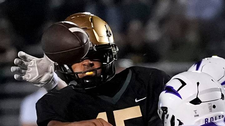 West’s Reece Wheeler (15) passes the ball as a host of Bolts pressure him during a high school football game Sept. 26, 2025 at Iowa City West in Iowa City, Iowa. West’s Reece Wheeler (15) passes the ball as a host of Bolts pressure him during a high school football game Sept. 26, 2025 at Iowa City West in Iowa City, Iowa.