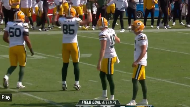 Packers players prepare for a field goal attempt.