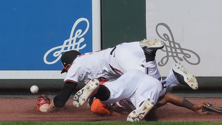 Sep 19, 2024; Baltimore, Maryland, USA; Baltimore Orioles outfielders Cedric Mullins (31) and Austin Slater (15) run into each other attempting to catch a ball in the ninth inning against the San Francisco Giants at Oriole Park at Camden Yards. Mandatory Credit: Mitch Stringer-Imagn Images