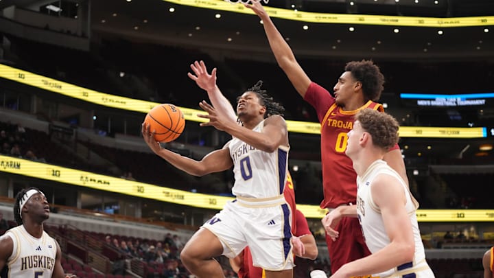 Mar 11, 2026; Chicago, IL, USA; Washington Huskies guard Quimari Peterson (0) is defended by Southern California Trojans guard Alijah Arenas (0) during the first half at United Center. 