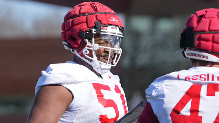 Arkansas Razorbacks offensive tackle Corey Robinson talking with fullback Maddox Lassiter during spring practice drills in Fayetteville, Ark.