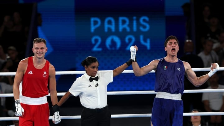 Marco celebrates after being declared the winner by judges after split decision 