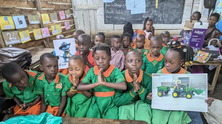 Students of the Evangelist Nsubuga Ibrahim fellowship school show support for Levi Wright. 