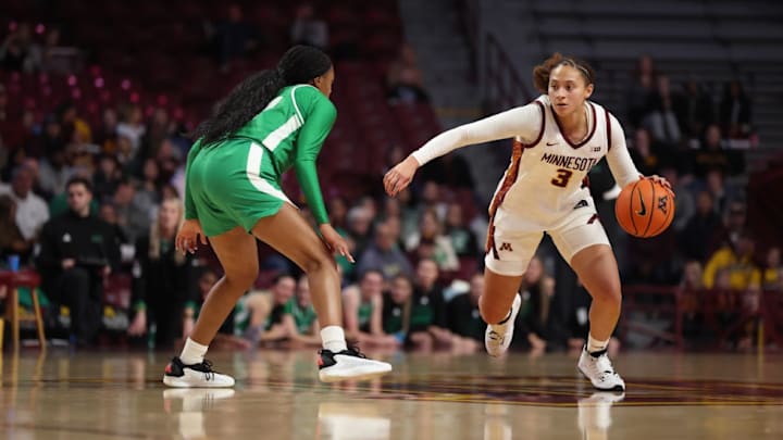 Amaya Battle trying to get past a North Dakota defender in Minnesota's season opener.