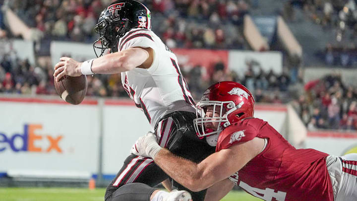 Texas Tech's Will Hammond (15) is sacked by Arkansas' Anton Juncaj (4) in the end zone for a safety during the AutoZone Liberty Bowl. Texas Tech's Will Hammond (15) is sacked by Arkansas' Anton Juncaj (4) in the end zone for a safety during the AutoZone Liberty Bowl.