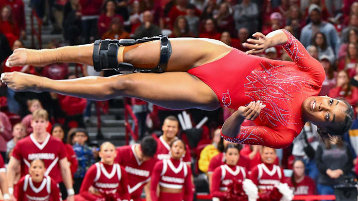 Arkansas Razorbacks gymnast Frankie Price locks down the upset with a 9.950 on the floor against the defending national champion LSU Tigers at Bud Walton Arena in Fayetteville, Ark.