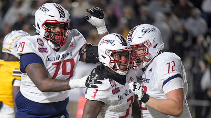 South Alabama running back Kentrel Bullock celebrates a touchdown run with teammates.