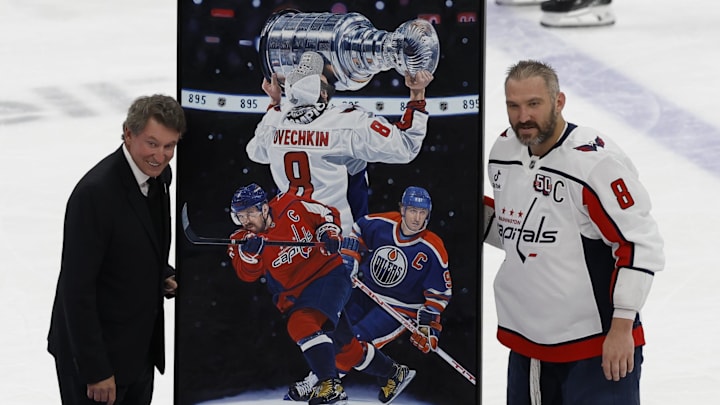 Apr 6, 2025; Elmont, New York, USA: Washington Capitals left wing Alex Ovechkin (8) is honored with a painting by artist Tony Harris by former Canadian-American ice hockey player Wayne Gretzky after scoring in the during the second period against the New York Islanders at UBS Arena. Ovechkin scored the 895th goal of his career, breaking the NHL all-time career goals record previously held by Wayne Gretzky at UBS Arena. Mandatory Credit: Geoff Burke-Imagn Images
