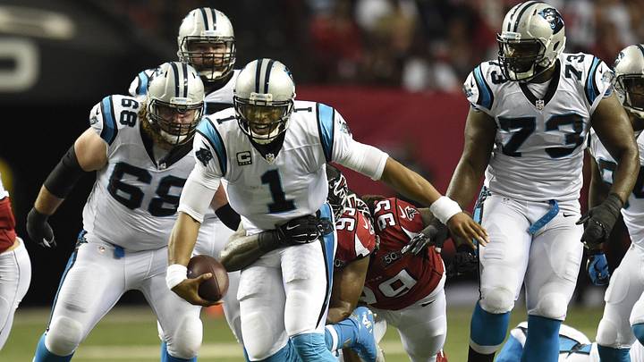 Carolina Panthers quarterback Cam Newton (1) carries the ball as he tries to escape Atlanta Falcons defensive end Malliciah Goodman Carolina Panthers quarterback Cam Newton (1) carries the ball as he tries to escape Atlanta Falcons defensive end Malliciah Goodman