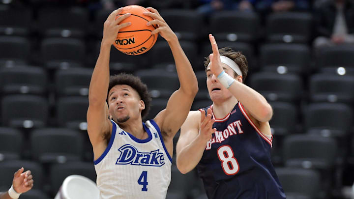 Mar 8, 2025; St. Louis, MO, Drake Bulldogs guard Isaiah Jackson (4) pulls a rebound away from Belmont Bruins guard Tyler Lundblade (8) during the first half at Enterprise Center. Mandatory Credit: Ron Johnson-Imagn Images