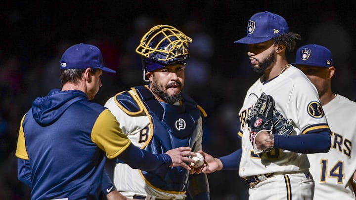 Apr 17, 2022; Milwaukee, Wisconsin, USA; Milwaukee Brewers pitcher Devin Williams (38) hands the ball to manager Craig Counsell during a pitching change in the eighth inning against the St. Louis Cardinals at American Family Field. 