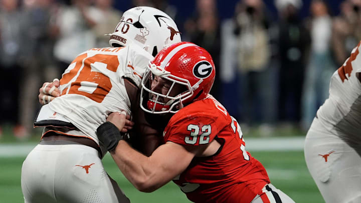 Georgia linebacker Chaz Chambliss (32) stops Texas running back Quintrevion Wisner (26) during the second half of the SEC championship game against Texas in Atlanta, on Saturday, Dec. 7, 2024.
