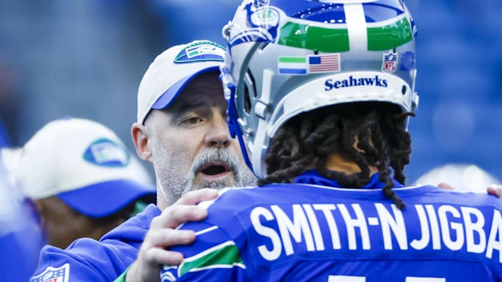 Oct 10, 2024; Seattle, Washington, USA; Seattle Seahawks offensive coordinator Ryan Grubb talks with wide receiver Jaxon Smith-Njigba (11) during pregame warmups against the San Francisco 49ers at Lumen Field. Mandatory Credit: Joe Nicholson-Imagn Images
