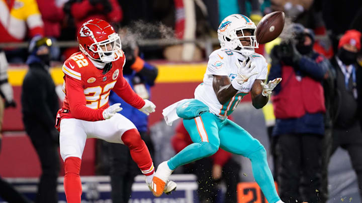 Jan 13, 2024; Kansas City, Missouri, USA; Miami Dolphins wide receiver Tyreek Hill (10) catches a pass ahead of Kansas City Chiefs cornerback Trent McDuffie (22) during the first half of the 2024 AFC wild card game at GEHA Field at Arrowhead Stadium. Mandatory Credit: Jay Biggerstaff-Imagn Images