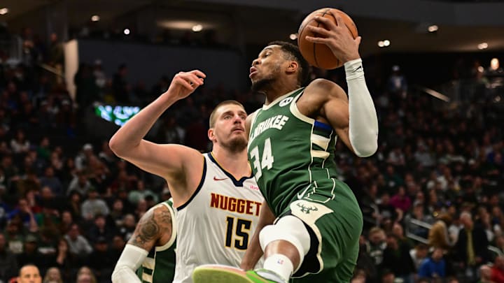 Feb 27, 2025; Milwaukee, Wisconsin, USA: Milwaukee Bucks forward Giannis Antetokounmpo (34) grabs a rebound against Denver Nuggets center Nikola Jokic (15) in the third quarter at Fiserv Forum. Mandatory Credit: Benny Sieu-Imagn Images Feb 27, 2025; Milwaukee, Wisconsin, USA: Milwaukee Bucks forward Giannis Antetokounmpo (34) grabs a rebound against Denver Nuggets center Nikola Jokic (15) in the third quarter at Fiserv Forum. Mandatory Credit: Benny Sieu-Imagn Images