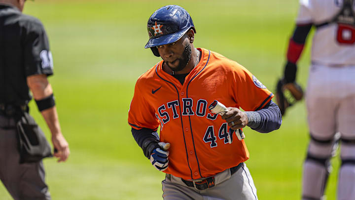 Houston Astros left fielder Yordan Alvarez jogs in an orange jersey and blue batting helmet during a game Houston Astros left fielder Yordan Alvarez jogs in an orange jersey and blue batting helmet during a game