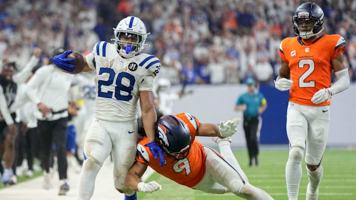 Denver Broncos safety Talanoa Hufanga (9) pushes Indianapolis Colts running back Jonathan Taylor (28) out of bounds Sunday, Sept. 14, 2025, during a game at Lucas Oil Stadium in Indianapolis.