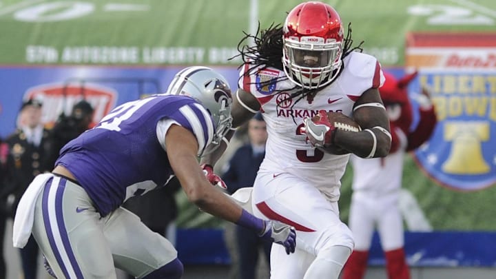 Arkansas running back Alex Collins (3) carries the ball against Kansas State defensive back Kendall Adams (21) during the first half at Liberty Bowl. 