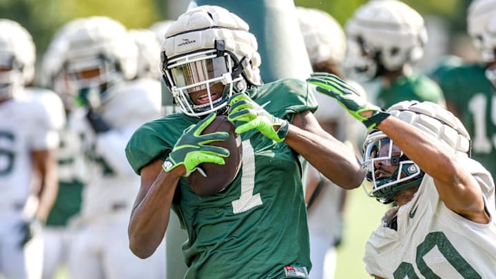 Michigan State receiver Antonio Gates Jr., left, catches a pass as defensive back Justin White