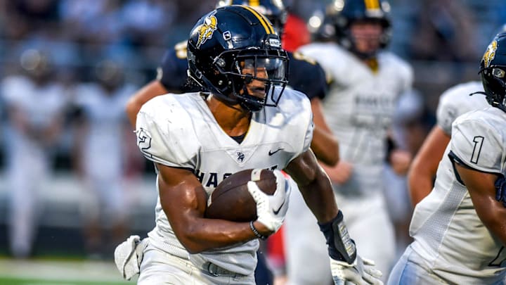 Haslett's Kory Amachree runs for a gain against DeWitt during the second quarter on Thursday, Aug. 24, 2023, at DeWitt High School.