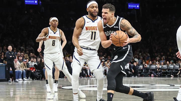Jan 4, 2026; Brooklyn, New York, USA;  Brooklyn Nets forward Michael Porter Jr. (17) looks to drive past Denver Nuggets guard Bruce Brown (11) in the third quarter at Barclays Center. Mandatory Credit: Wendell Cruz-Imagn Images