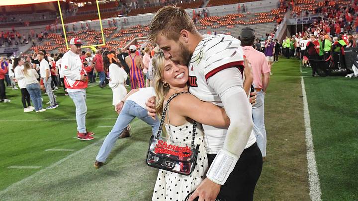 Saints quarterback Tyler Shough (9) kisses his wife Jordan at Memorial Stadium