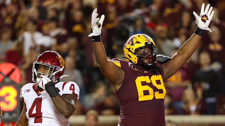 Oct 5, 2024; Minneapolis, Minnesota, USA; Minnesota Golden Gophers offensive lineman Aireontae Ersery (69) celebrates quarterback Max Brosmer's (16) touchdown against the USC Trojans during the first half at Huntington Bank Stadium. Mandatory Credit: Matt Krohn-Imagn Images