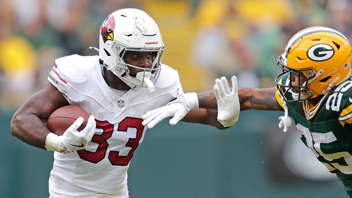 Arizona Cardinals running back Trey Benson runs for a first down against Green Bay Packers cornerback Keisean Nixon in 2024.
