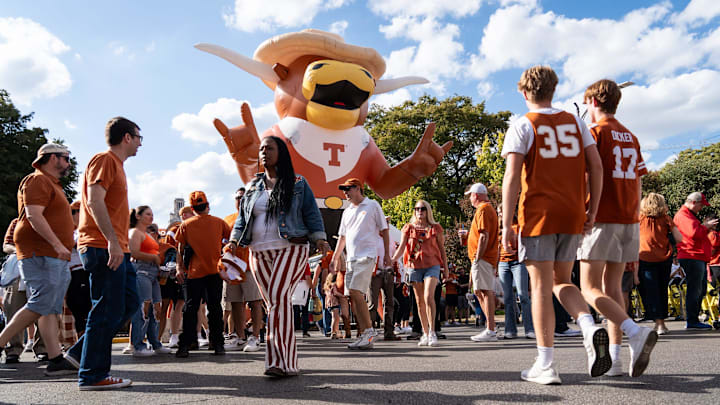 Texas fans stroll past an inflatable Hook 'Em on Bevo Boulevard ahead of the Longhorns' game against the Georgia Bulldogs.