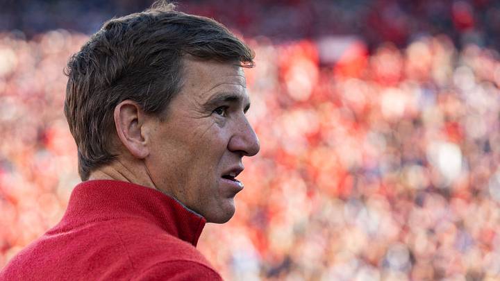 Former NFL QB Eli Manning stands on the sideline before the first round of the College Football Playoff.
