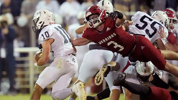 Washington High's Case Alexander leaps to make a tackle during a game against Marlow High School. Washington High's Case Alexander leaps to make a tackle during a game against Marlow High School.