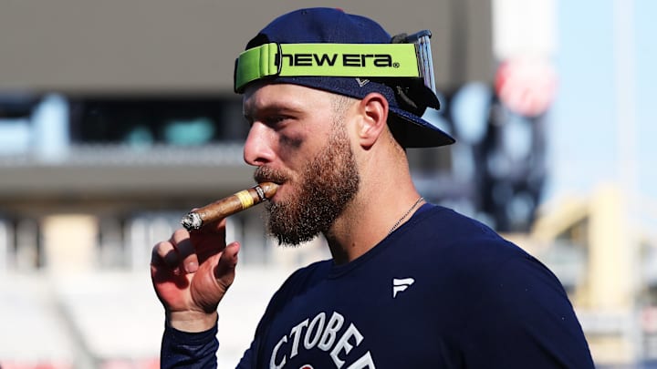 Chicago Cubs first baseman Michael Busch (29) celebrates with a victory cigar after defeating the Pittsburgh Pirates to secure a spot in the 2025 play-offs at PNC Park.
