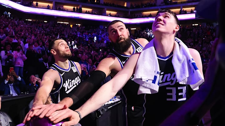 Feb 8, 2025; Sacramento, California, USA; Sacramento Kings guard Zach LaVine (8), center Jonas Valaciunas (17) and forward Jake LaRavia (33) look up after pushing the button to light the beam after a win against the New Orleans Pelicans at Golden 1 Center. Mandatory Credit: Kelley L Cox-Imagn Images
