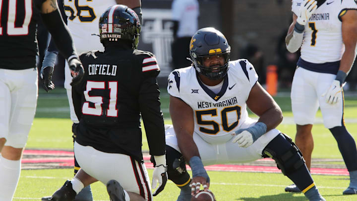 Nov 30, 2024; Lubbock, Texas, USA;  West Virginia Mountaineers offensive center Brandon Yates (50) prepares to snap the ball against Texas Tech Red Raiders defensive lineman Jayden Cofield (51) in the first half at Jones AT&T Stadium and Cody Campbell Field. Mandatory Credit: Michael C. Johnson-Imagn Images