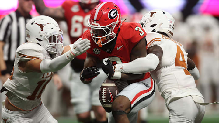 Dec 7, 2024; Atlanta, GA, USA; Georgia Bulldogs running back Nate Frazier (3) fumbles the ball against Texas Longhorns defensive back Andrew Mukuba (4) during the second half in the 2024 SEC Championship game at Mercedes-Benz Stadium. Mandatory Credit: Brett Davis-Imagn Images