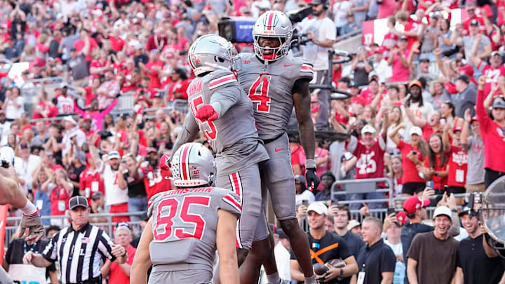Oct 5, 2024; Columbus, OH, USA; Ohio State Buckeyes wide receiver Jeremiah Smith (4) celebrates a touchdown with tight end Jelani Thurman (15) and tight end Bennett Christian (85) during the second half of the NCAA football game at Ohio Stadium. Ohio State won 35-7.