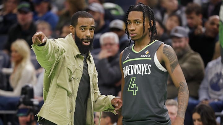 Nov 26, 2024; Minneapolis, Minnesota, USA; Minnesota Timberwolves guard Rob Dillingham (4) listens to guard Mike Conley (10) during a timeout in the fourth quarter against the Houston Rockets at Target Center. Mandatory Credit: Bruce Kluckhohn-Imagn Images