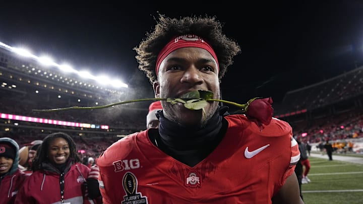 Ohio State Buckeyes safety Caleb Downs leaves the field with a rose in his mouth following the 42-17 win over the Tennessee Volunteers in the College Football Playoff first round game at Ohio Stadium in Columbus on Dec. 21, 2024. Ohio State will face Oregon in the Rose Bowl.