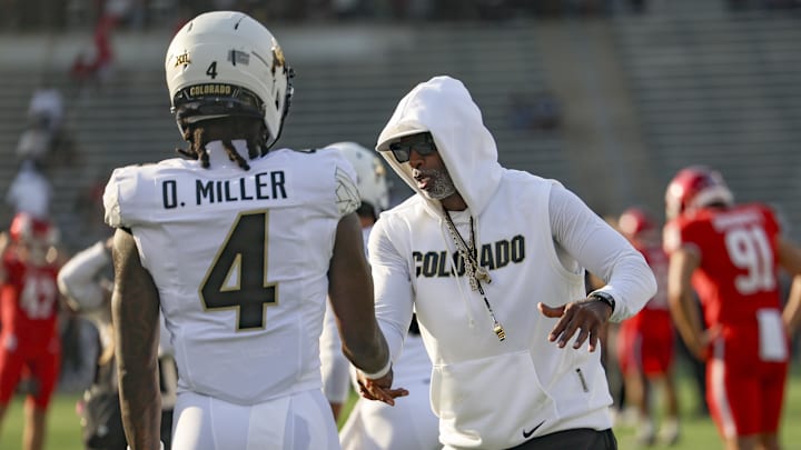 Sep 12, 2025; Houston, Texas, USA; Colorado Buffaloes head coach Deion Sanders shakes hands with wide receiver Omarion Miller (4) before the game against the Houston Cougars at TDECU Stadium. Mandatory Credit: Troy Taormina-Imagn Images