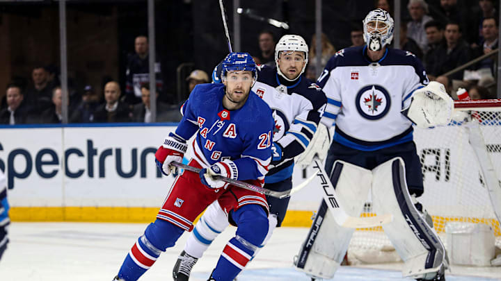 Mar 19, 2024; New York, New York, USA; New York Rangers center Barclay Goodrow (21) and Winnipeg Jets defenseman Neal Pionk (4) battle in front of Winnipeg Jets goalie Connor Hellebuyck (37) during the first period at Madison Square Garden. Mandatory Credit: Danny Wild-Imagn Images